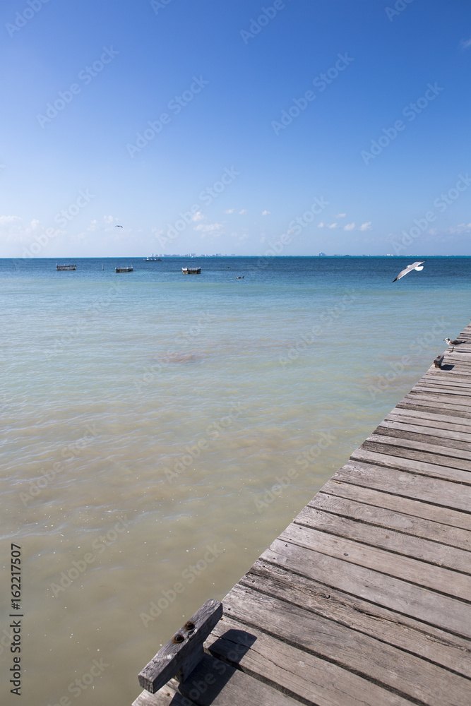 Wooden dock for small boats on the shores of the Caribbean sea.
