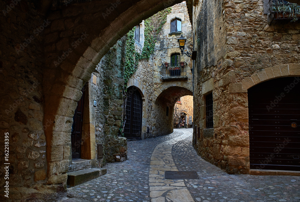 Doorgang of Carrer Major street in the medieval historic downtown of Pals. Bajo Ampurdan, Girona, Catalonia, Spain.
