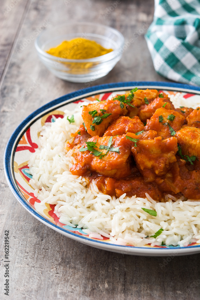 Chicken tikka masala with basmati rice on wooden table
Chicken tikka masala with basmati rice on wooden table