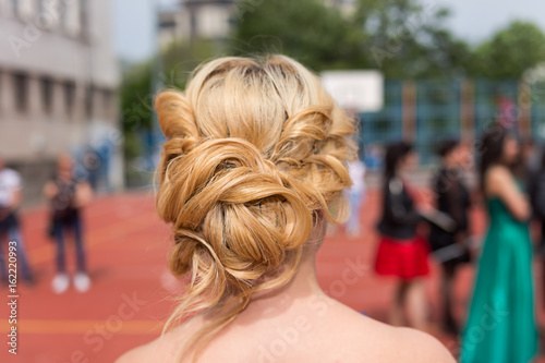 Modern beautiful haistyle hairdo of a girl at prom graduation