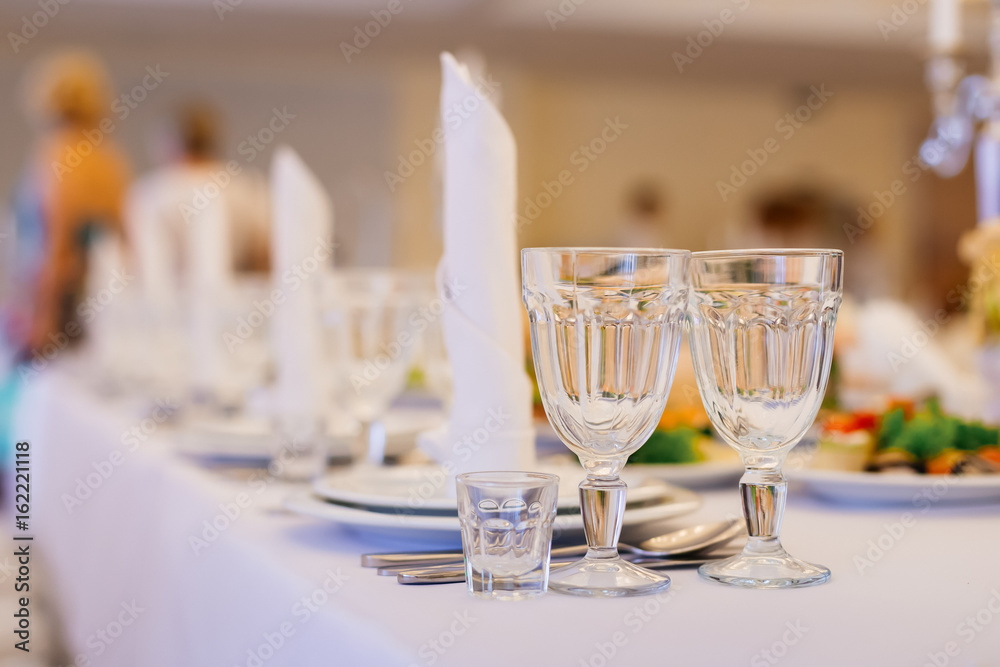 Empty glasses and dishes set in luxury restaurant