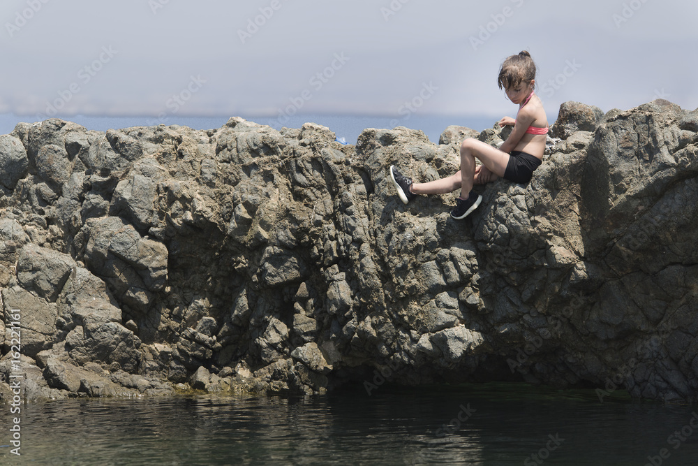 Girl climbed on some rocks