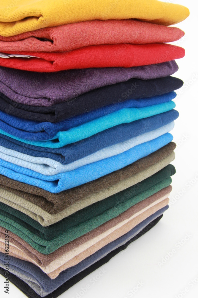 many colorful sweaters in a row..Still life of clothes, stack of sweater many colorful sweaters in a row..Still life of clothes, stack of sweater