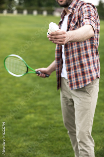 cropped view of man playing badminton on green field © LIGHTFIELD STUDIOS