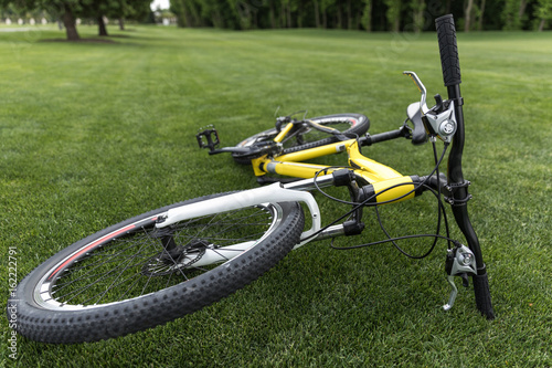 close up of modern sport bicycle lying on grass in park