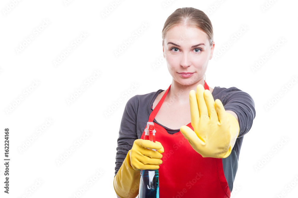 Pretty young housekeeper doing stop gesture Pretty young housekeeper doing stop gesture