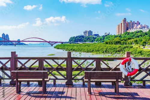 Pier with benches overlooking riverside © asiastock