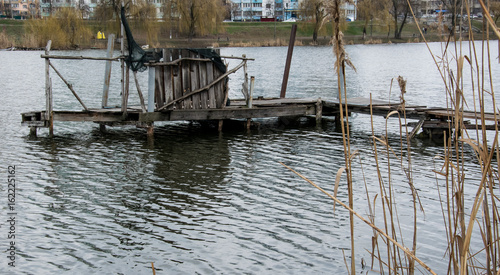View from the shore to the destroyed bridge on the lake