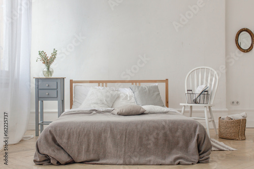 Interior of white and gray cozy bedroom