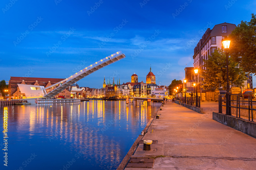 Old town in Gdansk and catwalk over Motlawa river at dusk, Poland