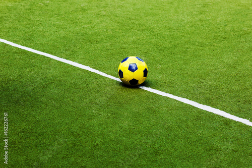 Yellow ball on the soccer field