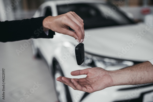 Salesperson with customer in car dealership