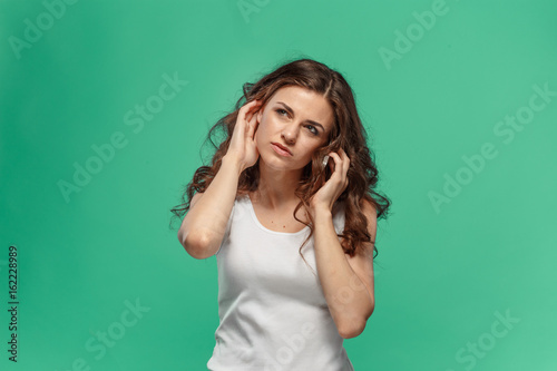 The portrait of disgusted woman with mobile phone