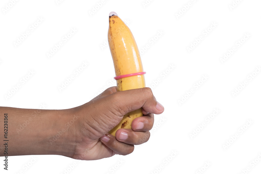 Condom on banana in hand on white background Condom on banana in hand on white background