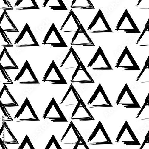 Seamless vector black and white background of hand drawn triangles. Lines textures of pen. Textile rapport. 
