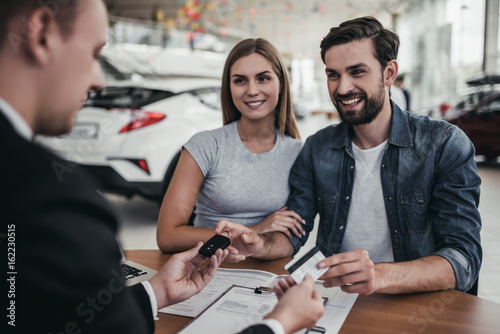 Couple at car dealership photo