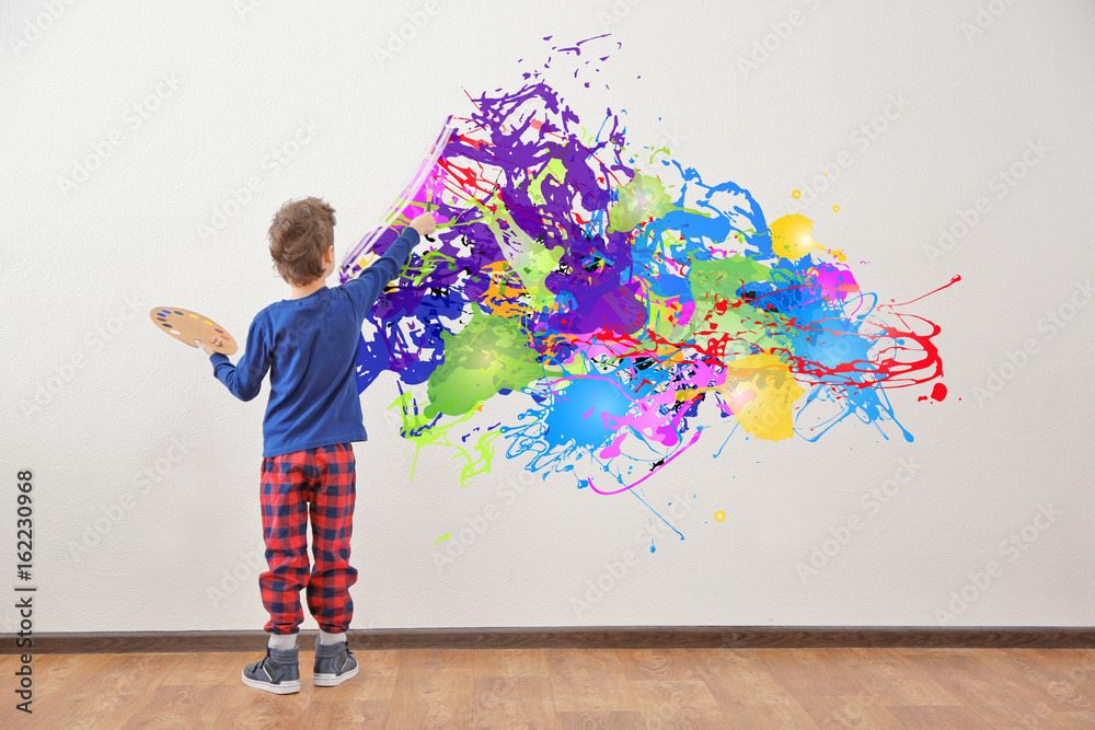 Cute little boy painting on wall in empty room Stock Photo Adobe Stock