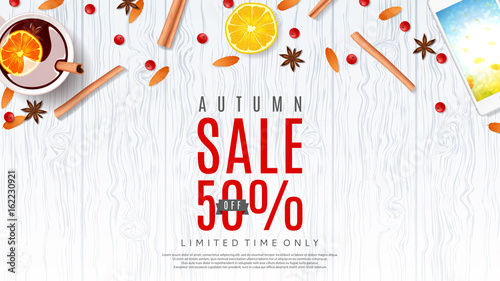 Beautiful web baner for autumn sale. Vector illustration. Top view on composition with cup of mulled wine, orange, rowan, cinnamon sticks on wooden texture.