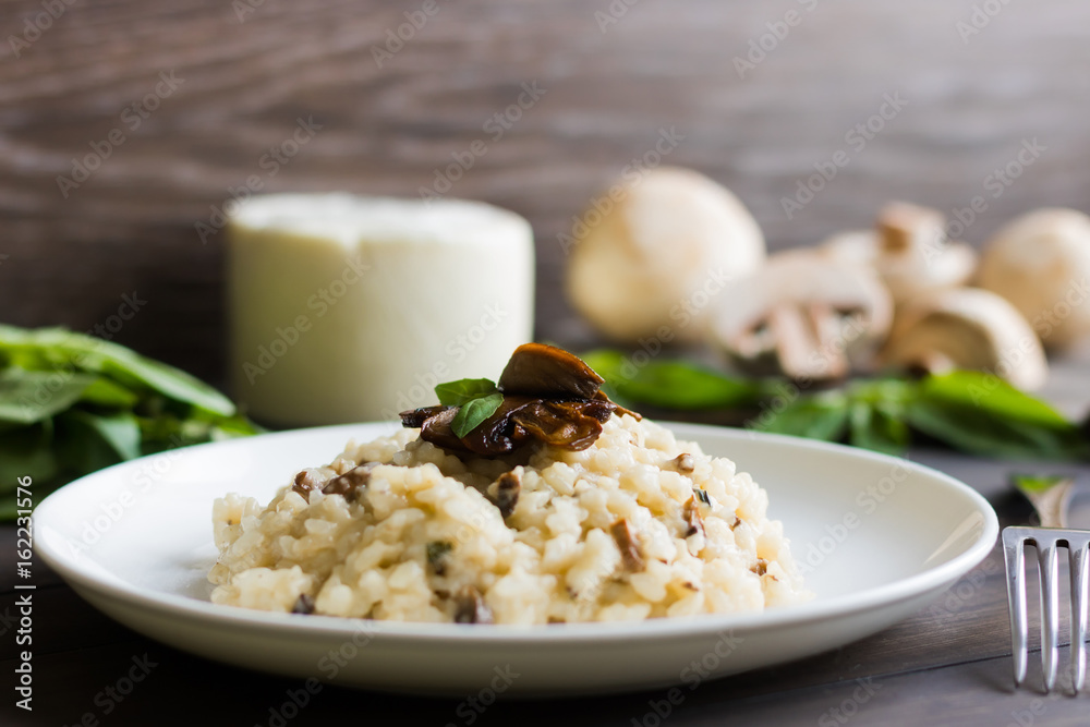 Risotto with mushrooms on a dark wooden background