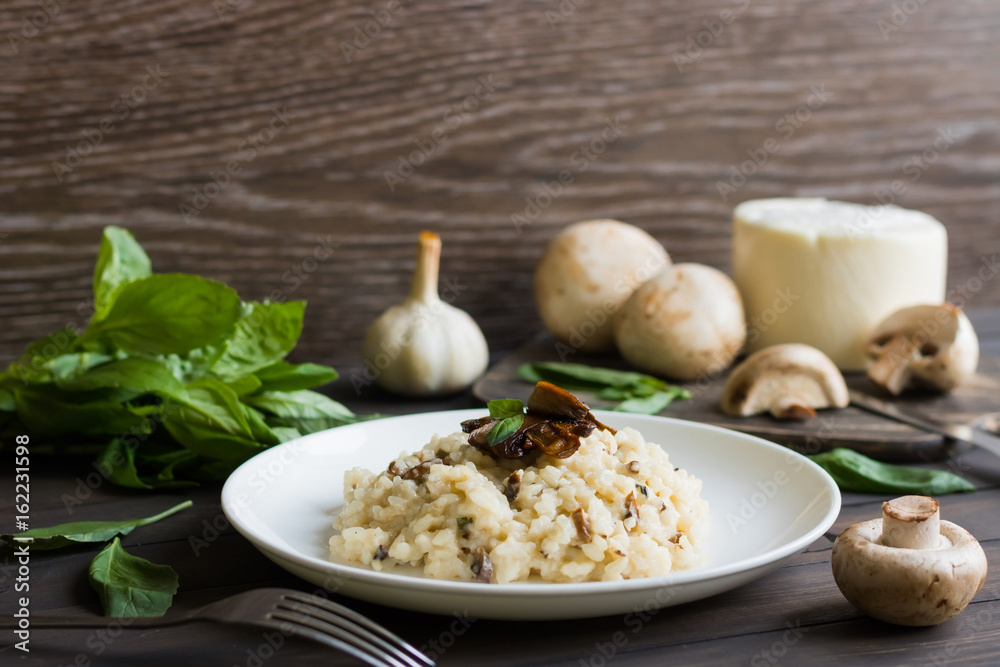Risotto with mushrooms on a dark wooden background Risotto with mushrooms on a dark wooden background