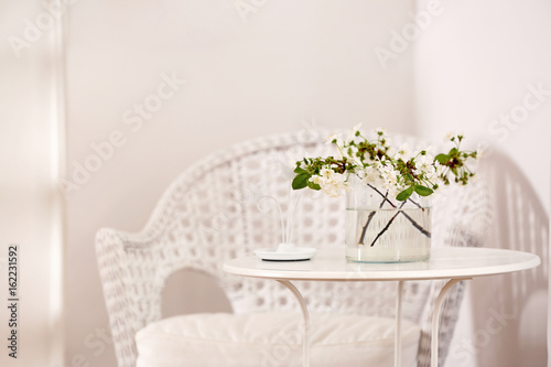 Vase with beautiful flowers on table at home