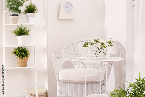 Beautiful modern veranda with cozy furniture and house plants