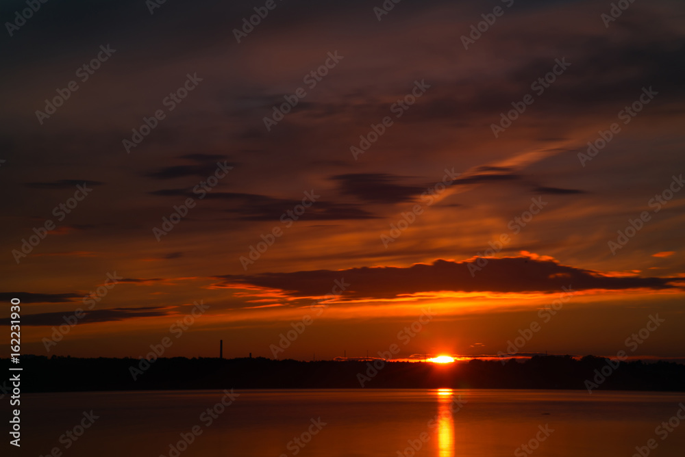 Orange and red sunset at coast of the lake Orange and red sunset at coast of the lake