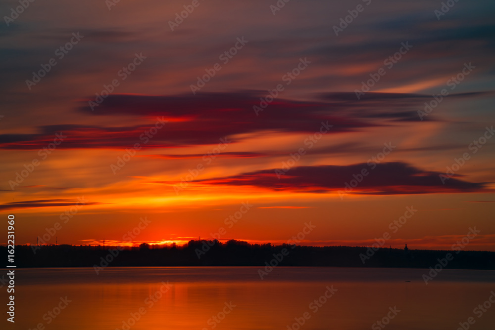 Orange and red sunset at coast of the lake Orange and red sunset at coast of the lake