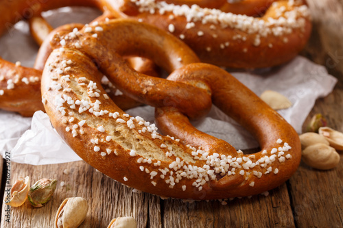 German meal: salted bread pretzel and pistachio close-up. Horizontal