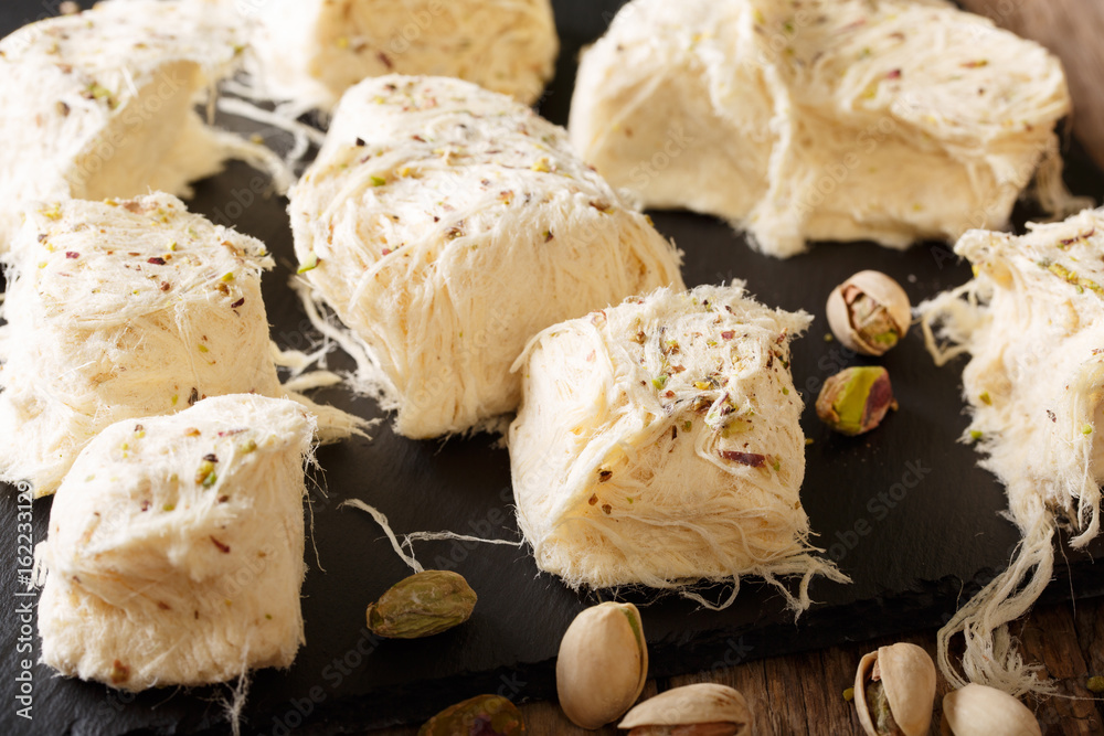 Fototapeta premium Delicious sweetness fresh dessert pismaniye with nuts pistachios macro. Horizontal