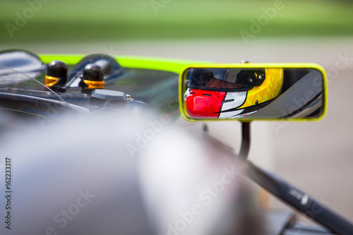 Pilot reflected in the rearviewer of his vehicle