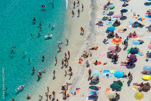 Fototapeta Naklejka Na Ścianę i Meble -  Overhead view of people at the beach, holiday concept