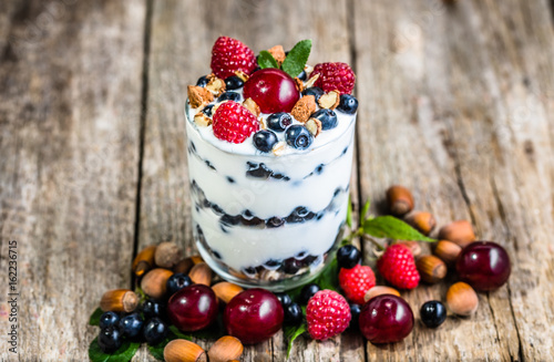 Healthy yogurt with fruits or sundae ice cream in a cup, summer dessert concept
