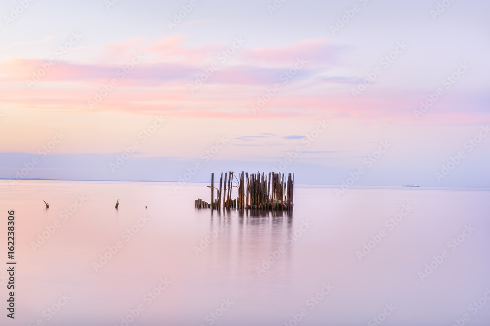 Sea landscape, the sea at sunset, twilight, long exposure. Calm sea. Beautiful beach. Silhouettes of hills on the shore in the haze in the distance.
Sea landscape, the sea at sunset, twilight, long exposure. Calm sea. Beautiful beach. Silhouettes of hills on the shore in the haze in the distance.