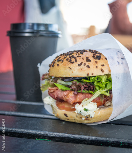 Bacon burger with coffee in background
