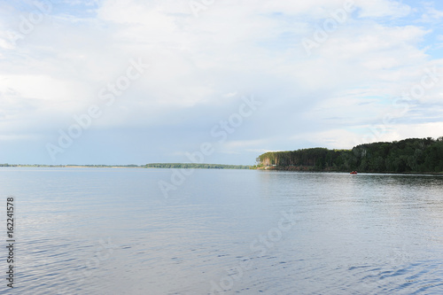 Water landscape on a summer clear day. Blue sky  clouds. Islands far away