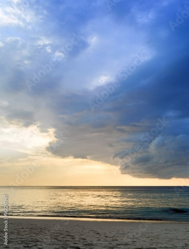 Storm clouds approaching from the roller tropical beach