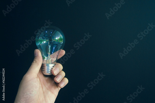 pick the light bulb on dark green background
