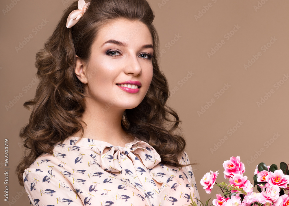 Fresh young girl in a light silk dress, smile, retro curls in the style of pin-up with a basket of flowers in her hands. Beauty face and body. Photos shot in studio Fresh young girl in a light silk dress, smile, retro curls in the style of pin-up with a basket of flowers in her hands. Beauty face and body. Photos shot in studio