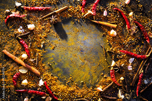 Variety Spices and herbs on black stone background, Top view with empty space background for texture. Italian food, eastern food concept.