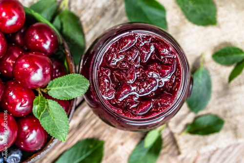 Sweet cherry confiture, preserves in glass jar made in autumn for winter