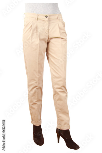 Slim woman in fashionable pants stands against a white background © Sylvia