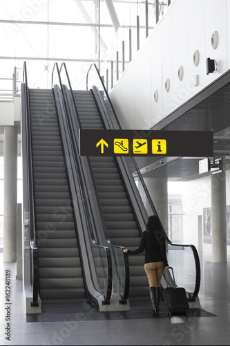 Woman on escalator at an airport