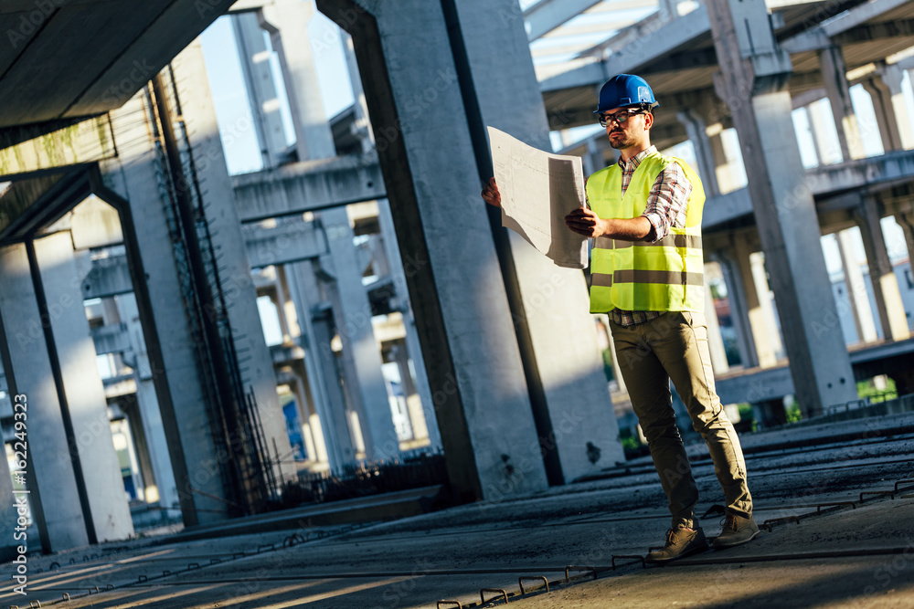 Picture of construction site engineer looking at plan Picture of construction site engineer looking at plan