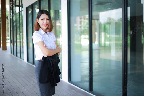 Free Download Modern business women casual outfits in the office with copy space, Business woman standing cross one's arm, Asian people young beautiful businesswoman smile. business concept - GFXLoad