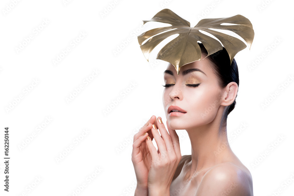 Φωτογραφία portrait of sensual woman with golden leaf on head isolated on white