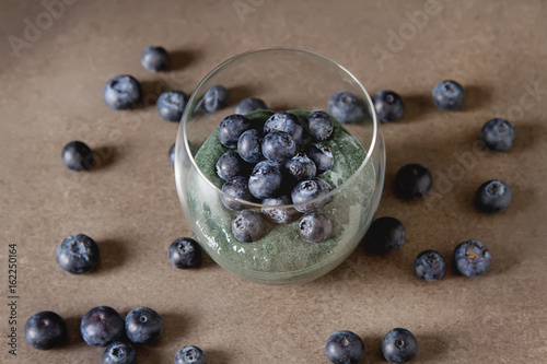 Fresh juicy bluesberries spirulina smoothies in the glass. Simple background. Healthy food. Detox. Lifestyle.