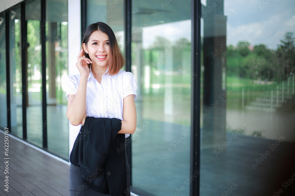 Modern business women casual outfits in the office with copy space, Business woman standing cross one's arm, Asian people young beautiful businesswoman smile. business concept Modern business women casual outfits in the office with copy space, Business woman standing cross one's arm, Asian people young beautiful businesswoman smile. business concept