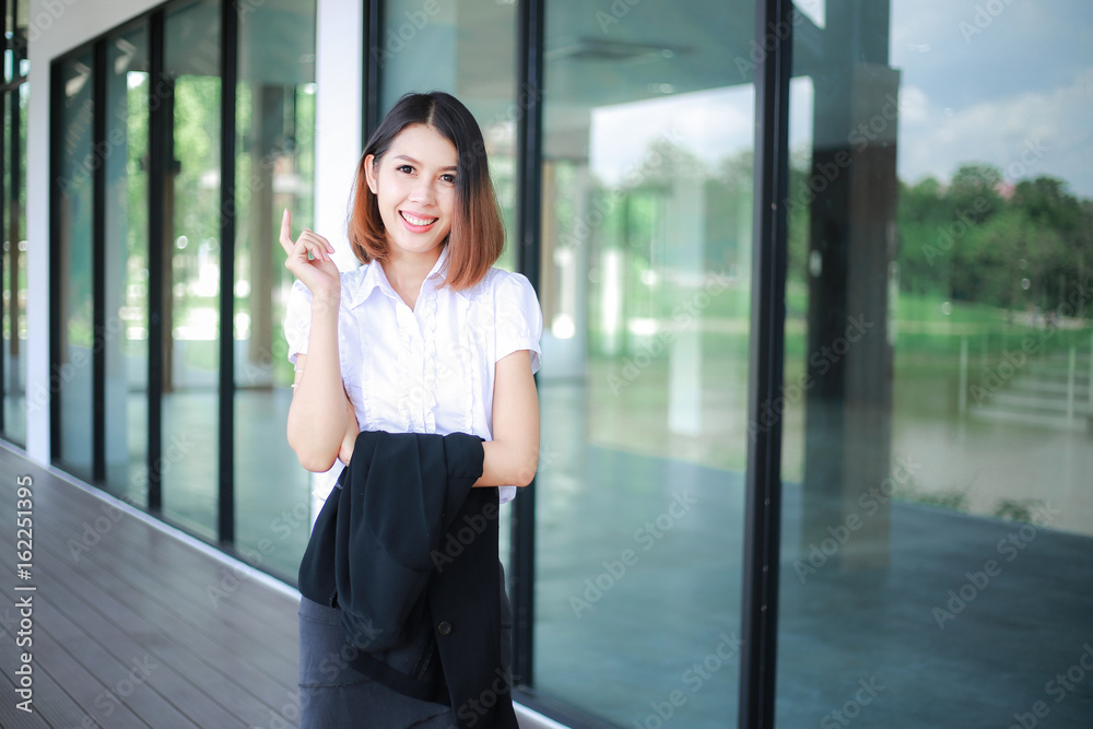 Modern business women casual outfits in the office with copy space, Business woman standing cross one's arm, Asian people young beautiful businesswoman smile. business concept Modern business women casual outfits in the office with copy space, Business woman standing cross one's arm, Asian people young beautiful businesswoman smile. business concept