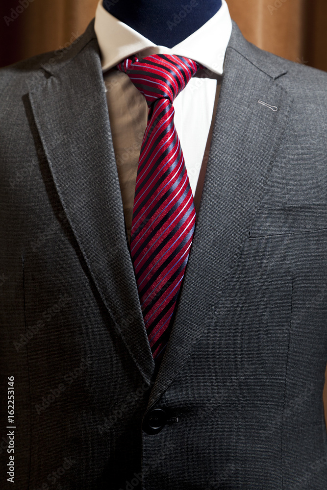 Photo of a grey suit with white shirt red patterned tie Stock Photo | Adobe Stock